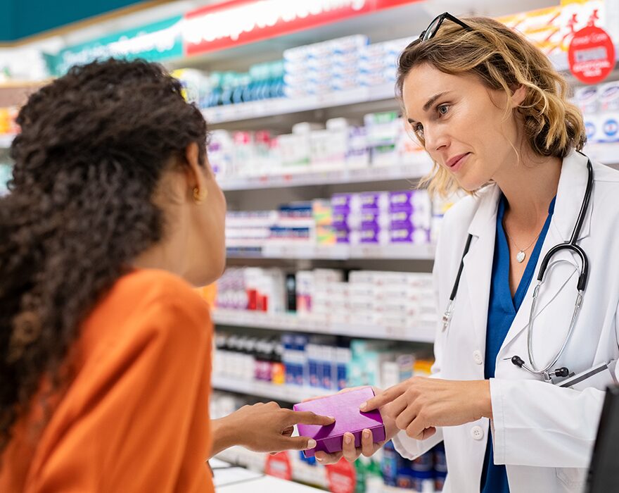 Pharmacist assisting a customer in a UK pharmacy
